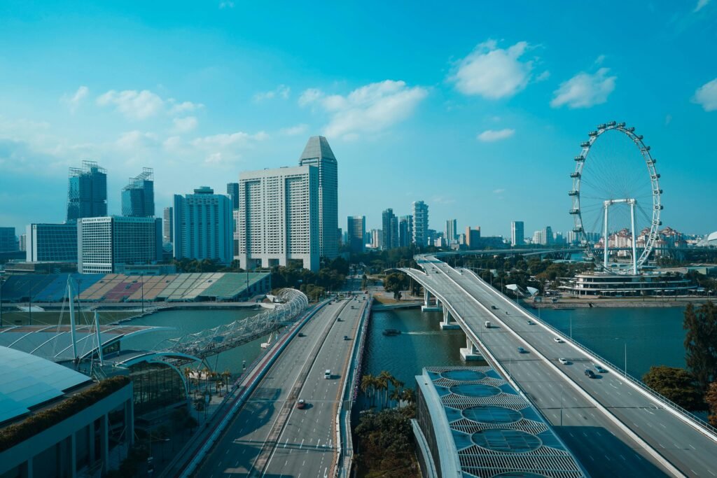 Scenic aerial shot of Singapore's skyline featuring the Helix Bridge, Marina Bay, and Singapore Flyer.